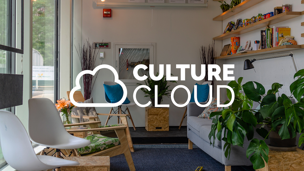 Living room with chairs and a couch with the CultureCloud logo on top