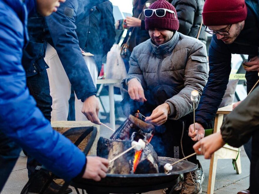 People toast marshmallows around a fire pit in Union Square