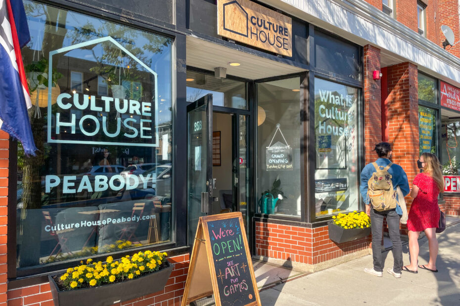 Two visitors standing outside the storefront of CultureHouse Peabody
