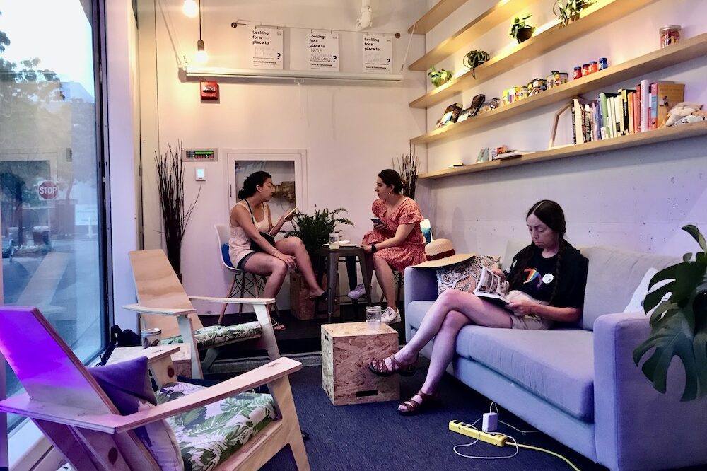 People sit on couches and chairs at the CultureHouse pop-up in Kendall Square