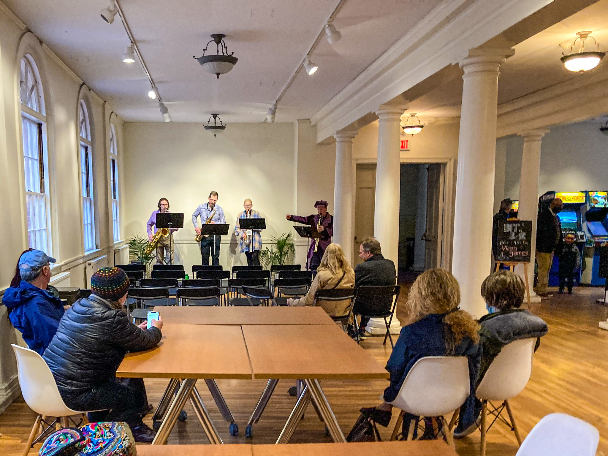 People sitting while a group of four play music on the stage.