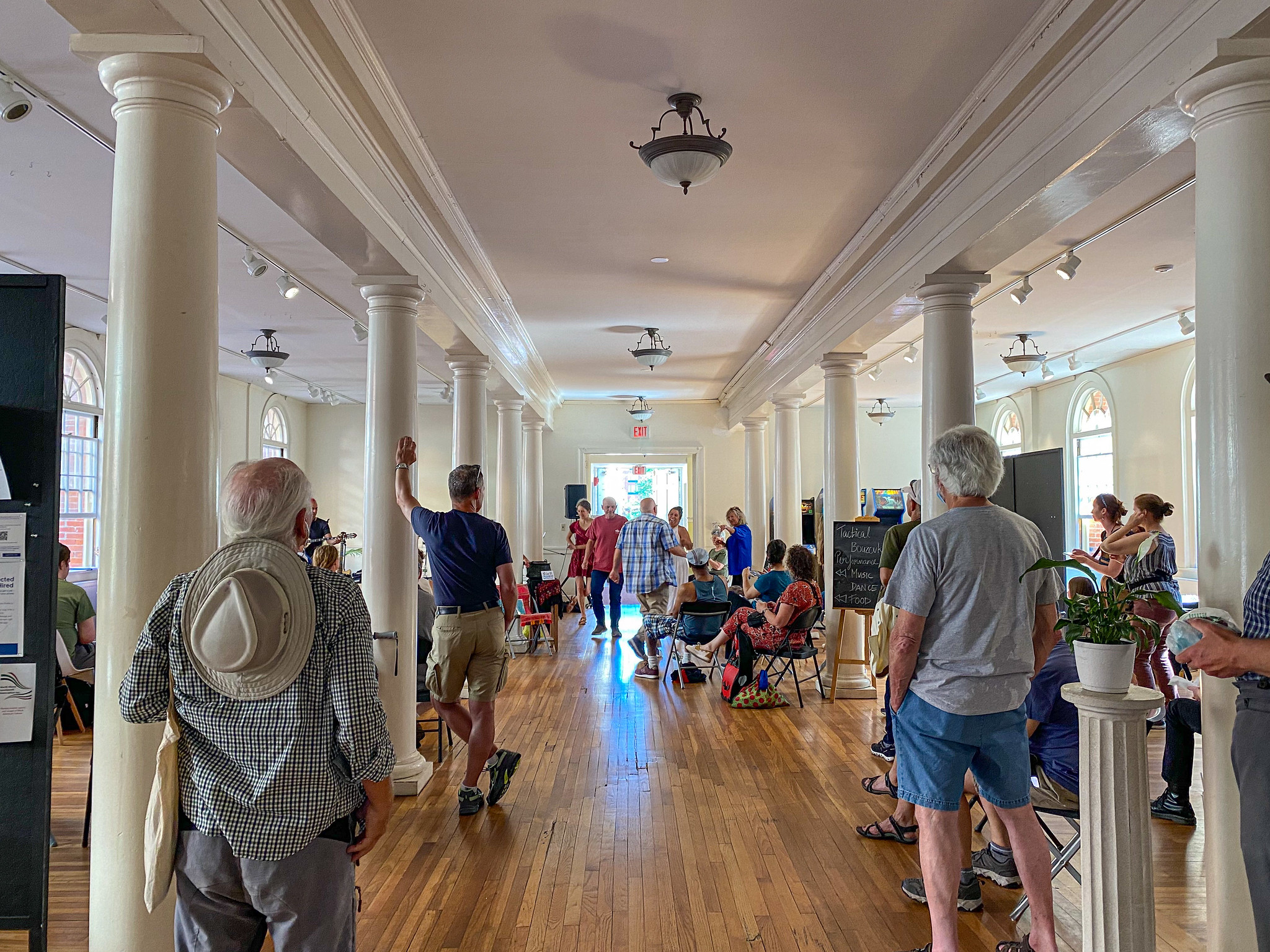 People stand around watching while people dance.