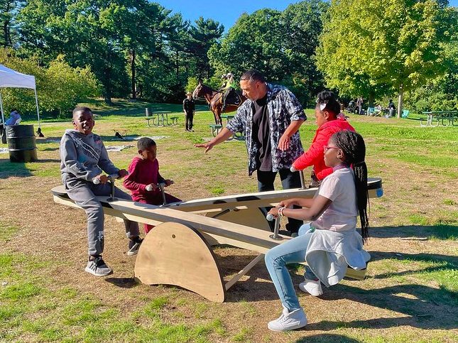 Kids playing on seesaws.