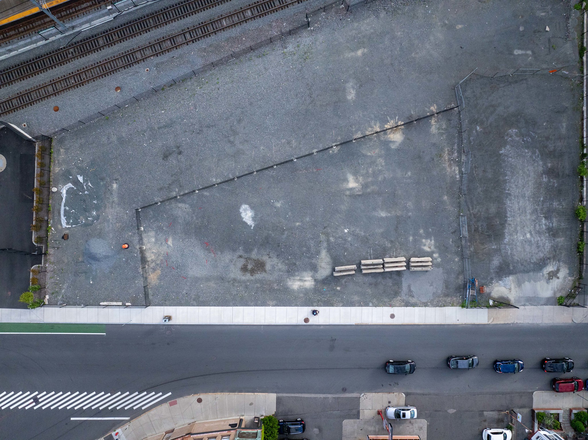 Top-down drone image of the empty Gilman Square lot