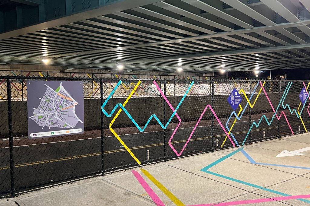 A map of East Somerville and Union Square highlighting the East Somerville business districts and safe routes to Broadway next to a painted sidewalk and abstract fence weaving