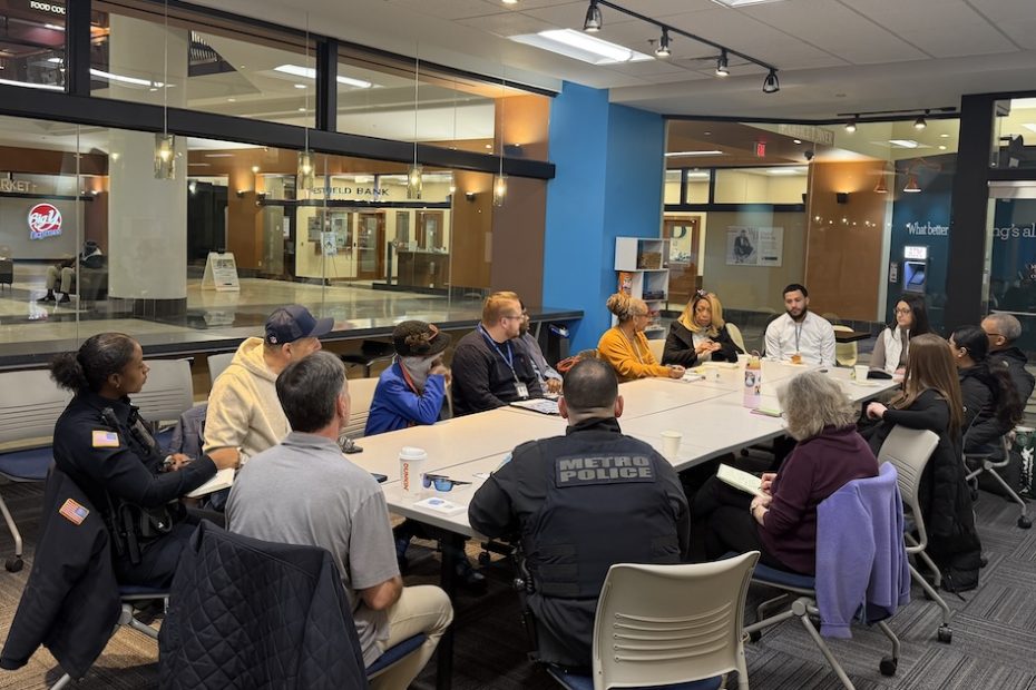Members of the community justice C3 gather at a conference table at Springfield Cultural Partnership's new pop-up space